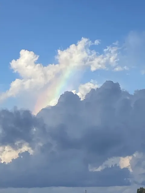 A rainbow showing above a bank of clouds near Venice, Louisiana