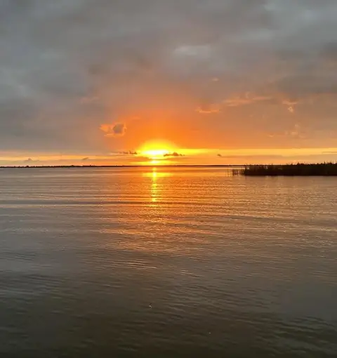 Sun on the horizon over the water in the Venice, Louisiana delta